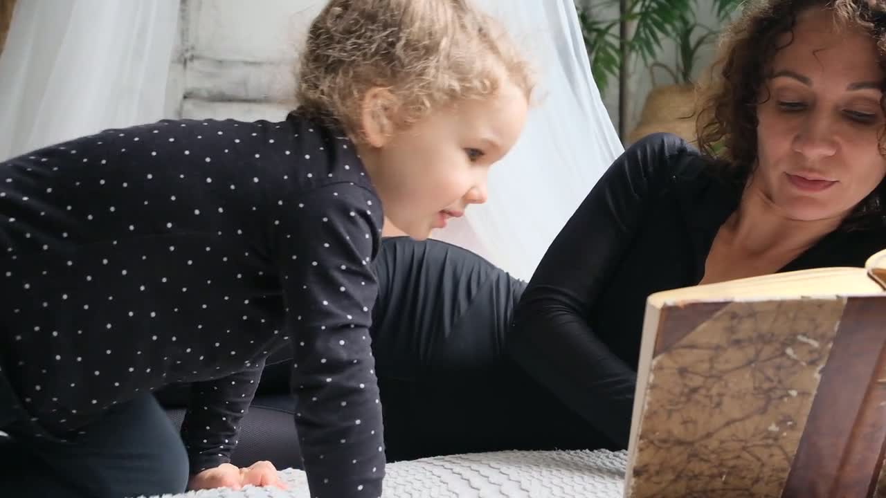 An adult reading a book with a young child