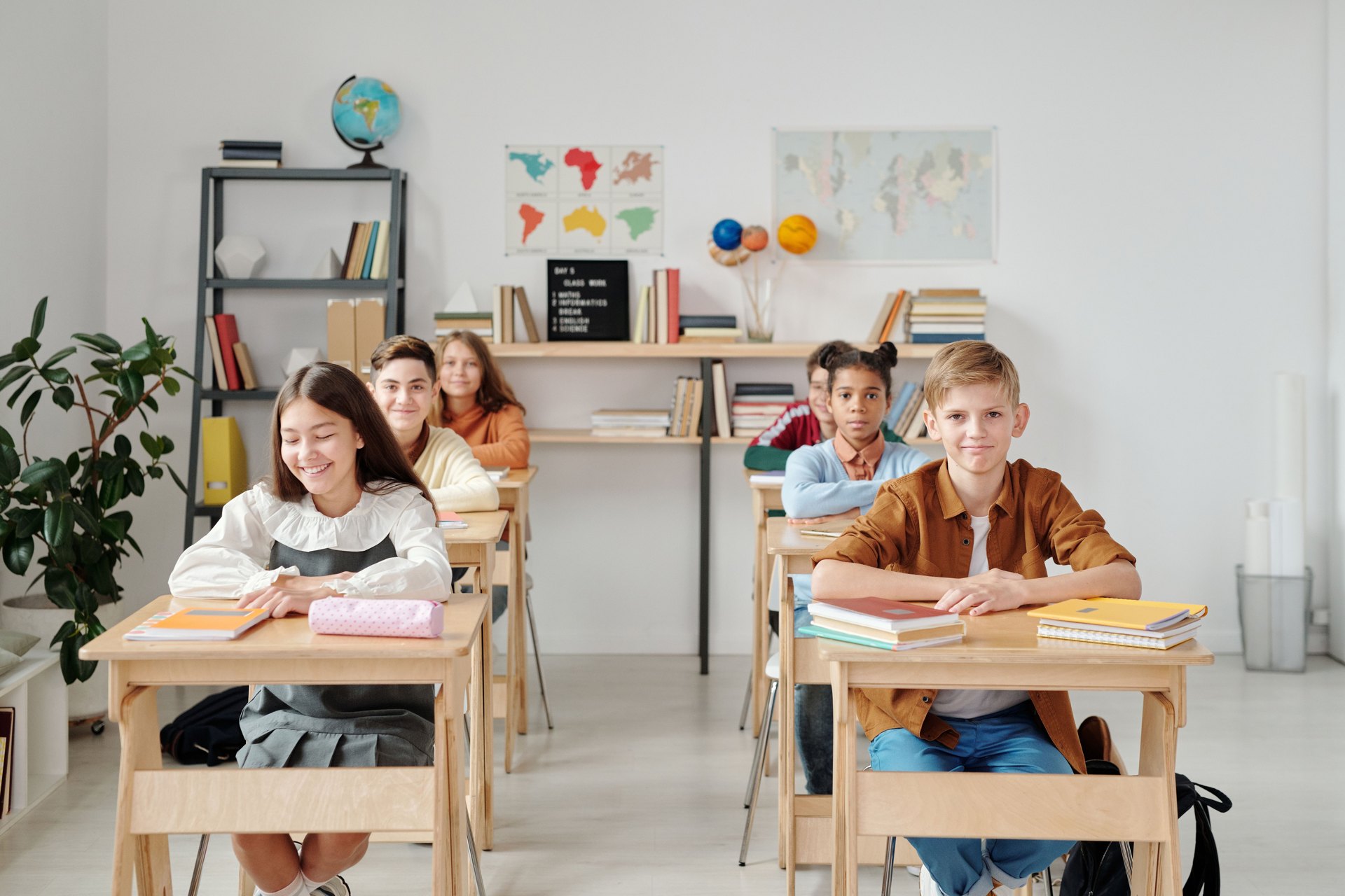 Students seated at desks in a bright classroom